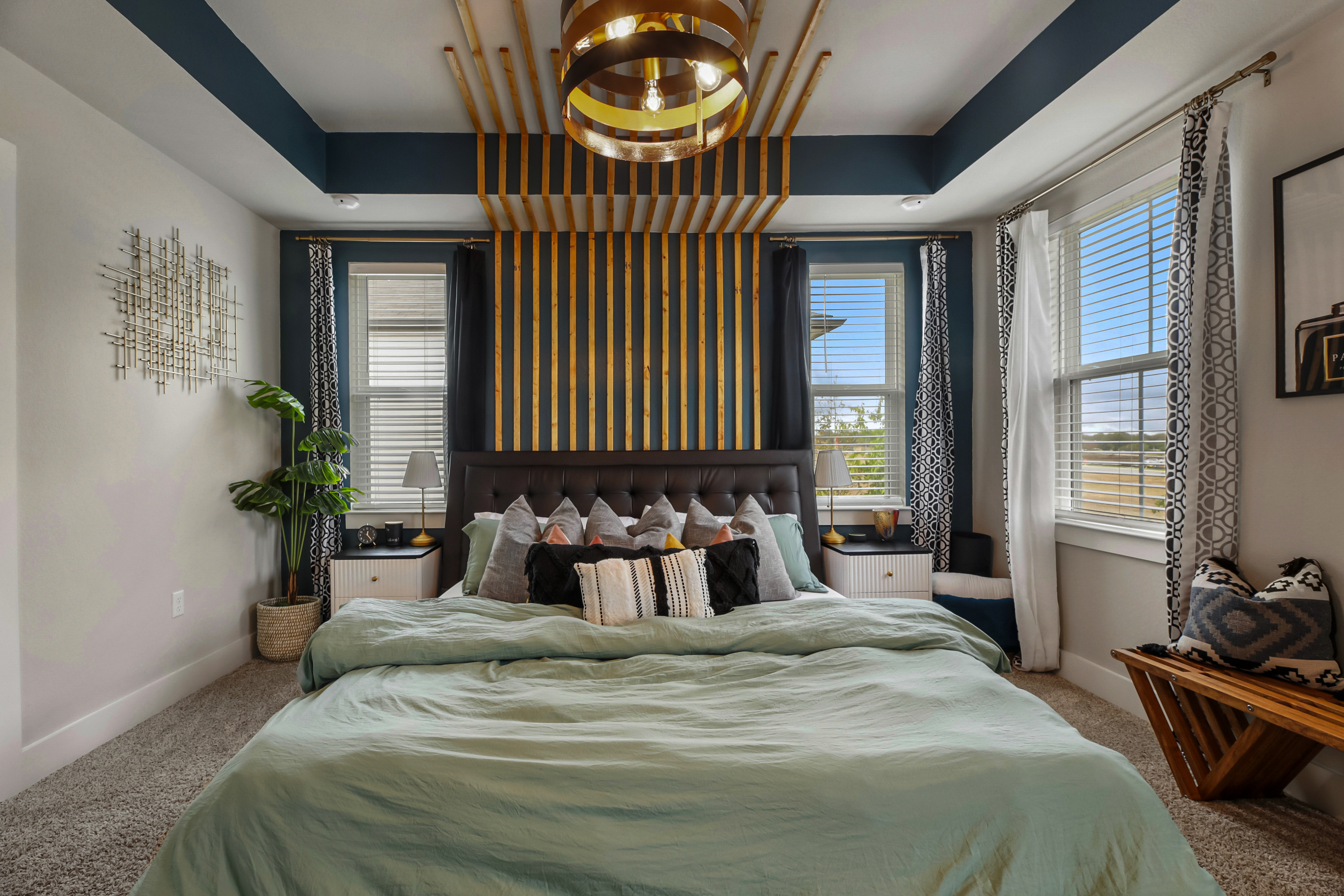 Bedroom detail showing layered textiles, cushions, and warm tones